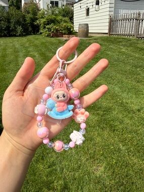 Cute Pink Beaded Keychain Phone Charm with a pink Labubu on Blue Rocking horse